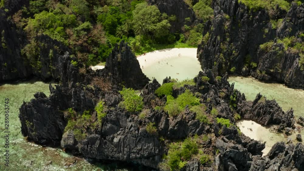 Aerial drone of tropical lagoon with sandy beach surrounded by cliffs. El nido, Philippines, Palawan. beautiful lagoon and karst scenery. Aerial drone of tropical lagoon with sandy beach surrounded by cliffs. El nido, Philippines, Palawan. beautiful lagoon and karst scenery.