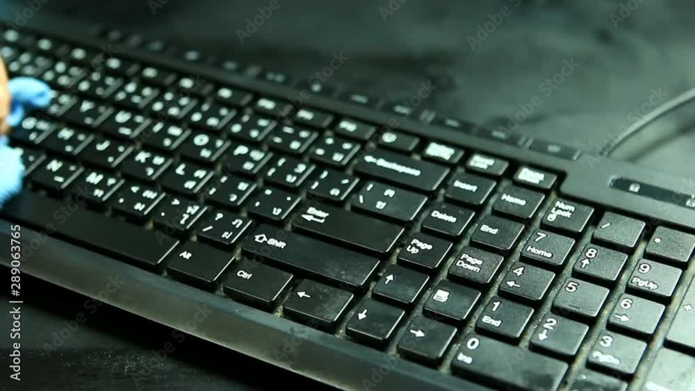 Man washing keyboard of personal computer in studio, Chiangmai Thailand Man washing keyboard of personal computer in studio, Chiangmai Thailand
