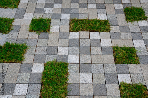 An unusual paved stone space in a public urban place with small areas of grass