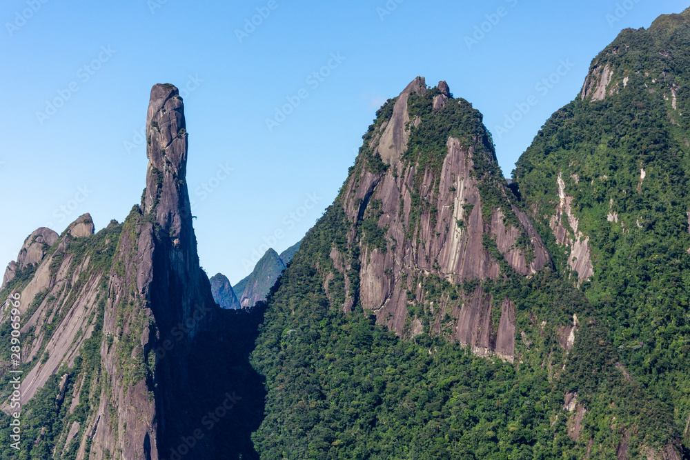 Fototapeta premium Postcard trail view where you can observe in detail de vegetation and topography of the to Serra dos Orgãos (Organs Mountain) with Finger's God highlighted in landscape.
