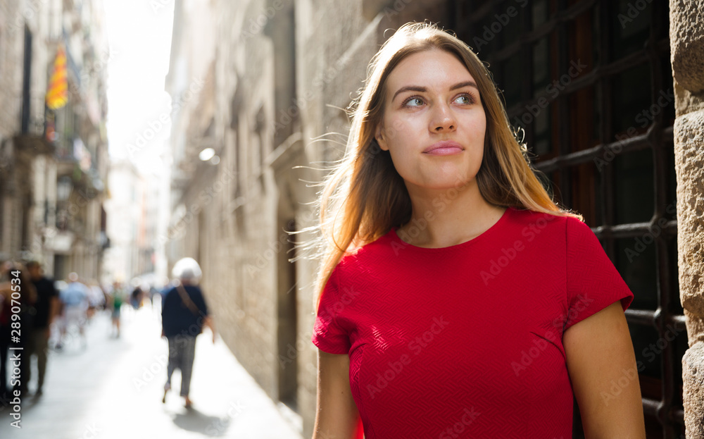 beautiful girl walks through the old European streets