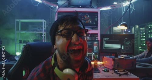 Hacker laughing then glaring into camera
