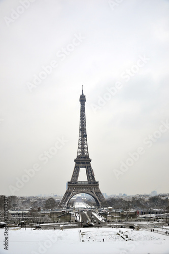 Fototapeta Naklejka Na Ścianę i Meble -  Paris, France - February 8th 2018 . Eiffel tower under snow. Snow is pretty rare in Paris. You can also see the flood of the river La Seine, happening in the same time.
