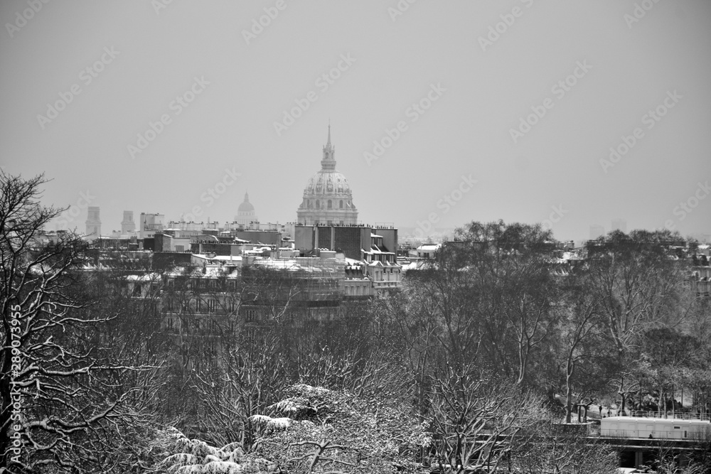 Paris, France - February 8th 2018 . Cupola of Invalides under snow. The Invalides was constructed for disabled person by the king Louis XIV. It's now the Army museum, an hospital and Napoleon's tomb.