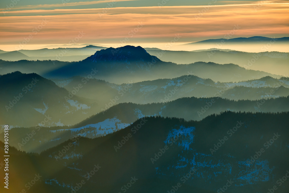 Obraz premium Aerial Landscape view from Ceahlău Mountains National Park at sunset in winter season,Sunset in Ceahlau Mountains
