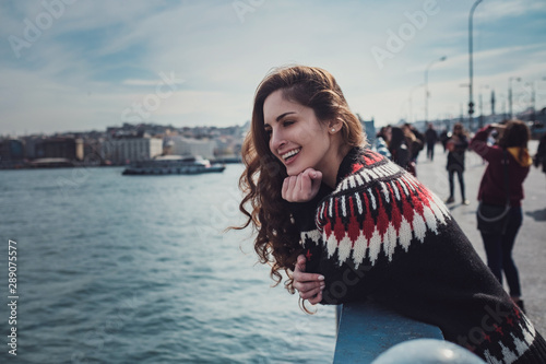 Photography Young smiling tourist woman on Galata bridge