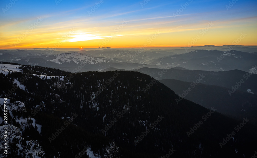 Aerial Landscape view from Ceahlău Mountains National Park at sunrise with fog in the winter season,sunrise in Ceahlau Mountains