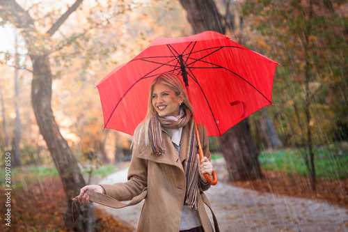 Bild auf Leinwand Happy young woman enjoy in autumn rain
