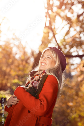Beautiful blonde in romantic autumn scenery