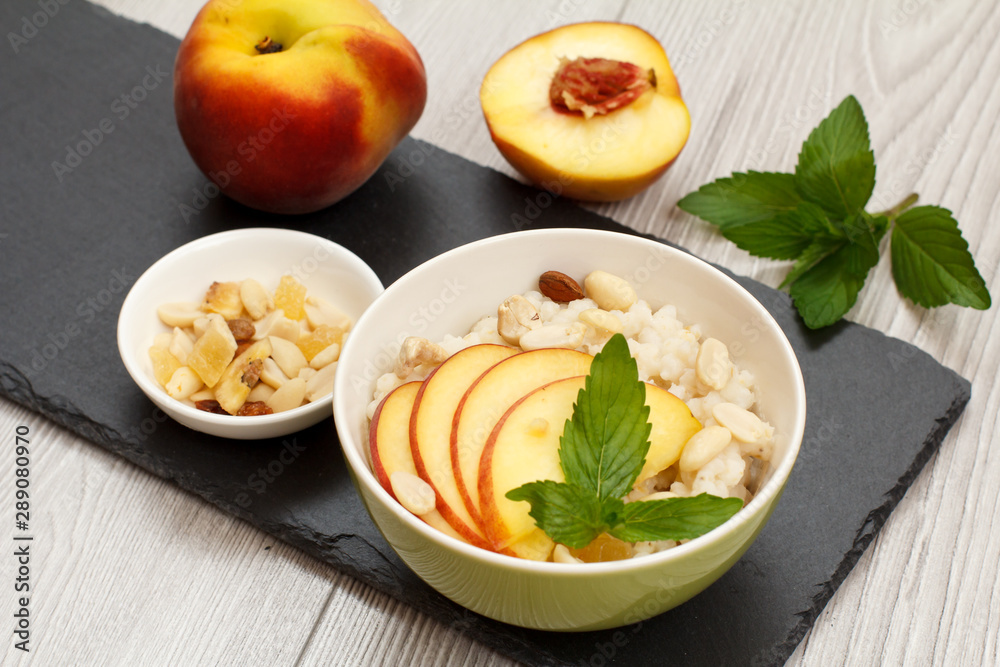 Sorghum salad with nuts and fresh peach on stone board. Sorghum salad with nuts and fresh peach on stone board.