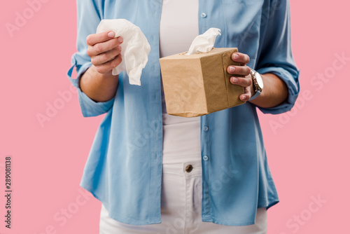 cropped view of woman with paper napkins, Isolated On pink