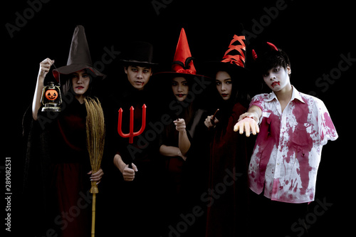 Group young Asian in costume Halloween party on black background.