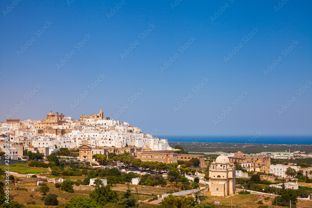 Ostuni white town skyline and Madonna della Grata church with clean blue sky, Brindisi, Apulia southern Italy. Europe
