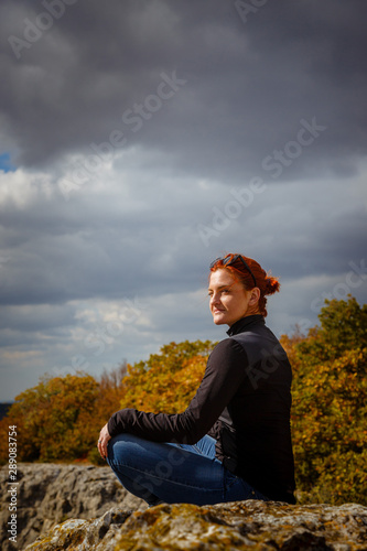 young fitness woman practice yoga at mountain peak cliff edge