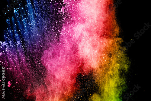 Abstract multicolored powder explosion on black background. Color dust particle splattered on background. © Pattadis