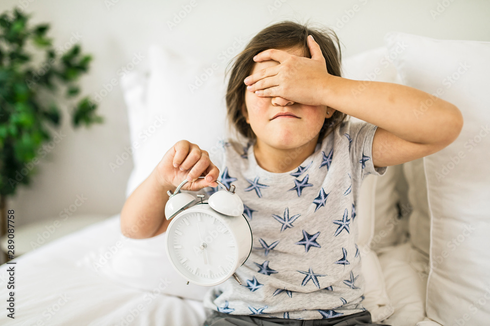 Portrait of depress girl sleeping and holding hand on alarm clock Portrait of depress girl sleeping and holding hand on alarm clock