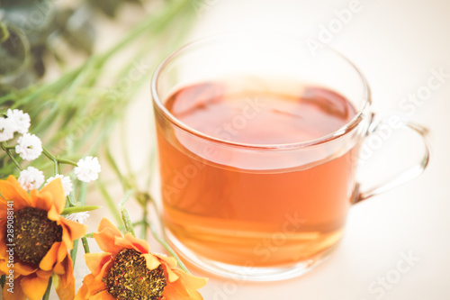 Autumn tea. Marigolds and tea cup autumn background