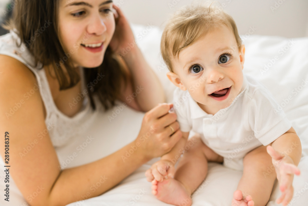 A Mother and baby on bed having fun A Mother and baby on bed having fun