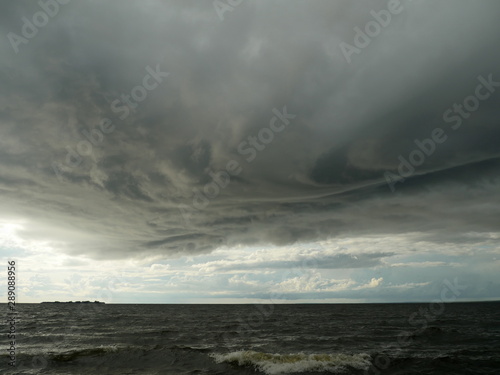 huge low dark clouds approaching the shore from the sea © mrivserg