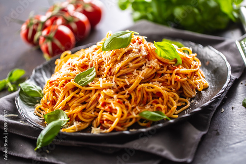 Pasta spaghetti toamto and bolognese sauce with oilve oil parmesan and basil photo