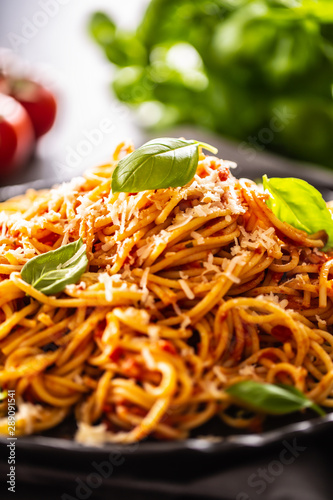 Pasta spaghetti toamto and bolognese sauce with oilve oil parmesan and basil photo