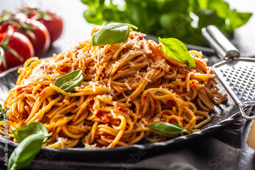 Pasta spaghetti toamto and bolognese sauce with oilve oil parmesan and basil photo