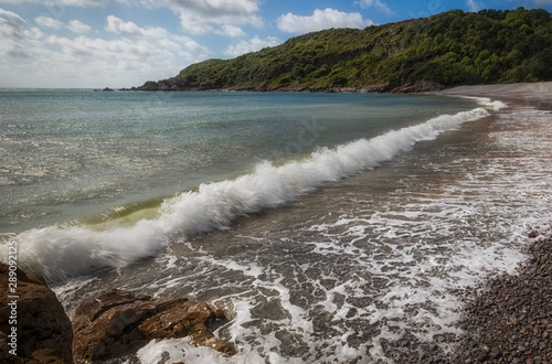 Crashing waves at Pwll Du Bay on the Gower peninsula in Swansea, South Wales, UK, once an extensive limestone quarry and also a popular smuggling cove.
