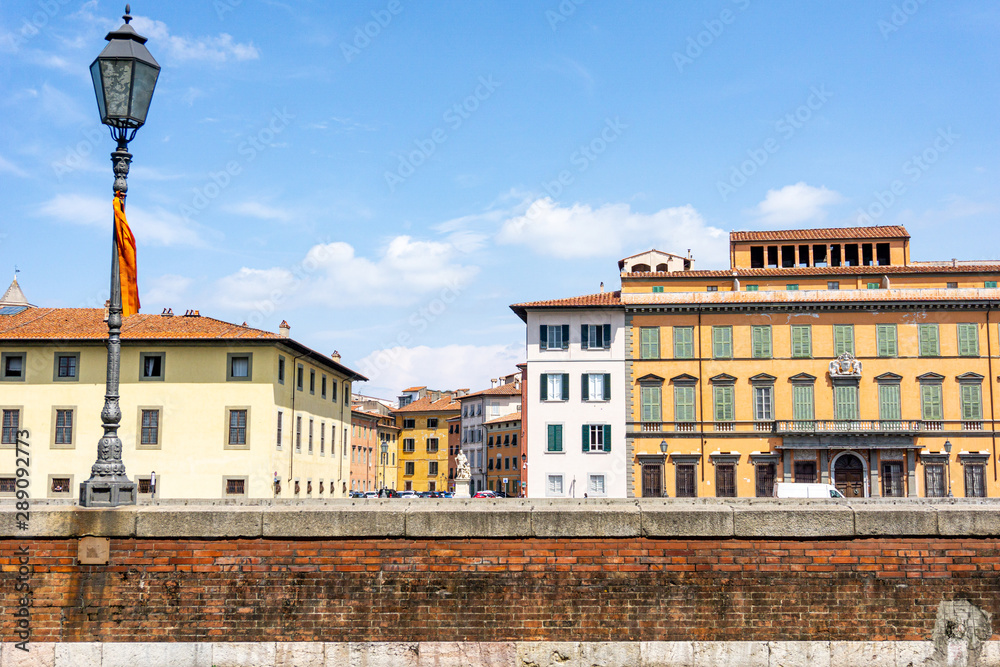 View of the street with beautiful, colorful buildings in Pisa,Tuscany, Italy