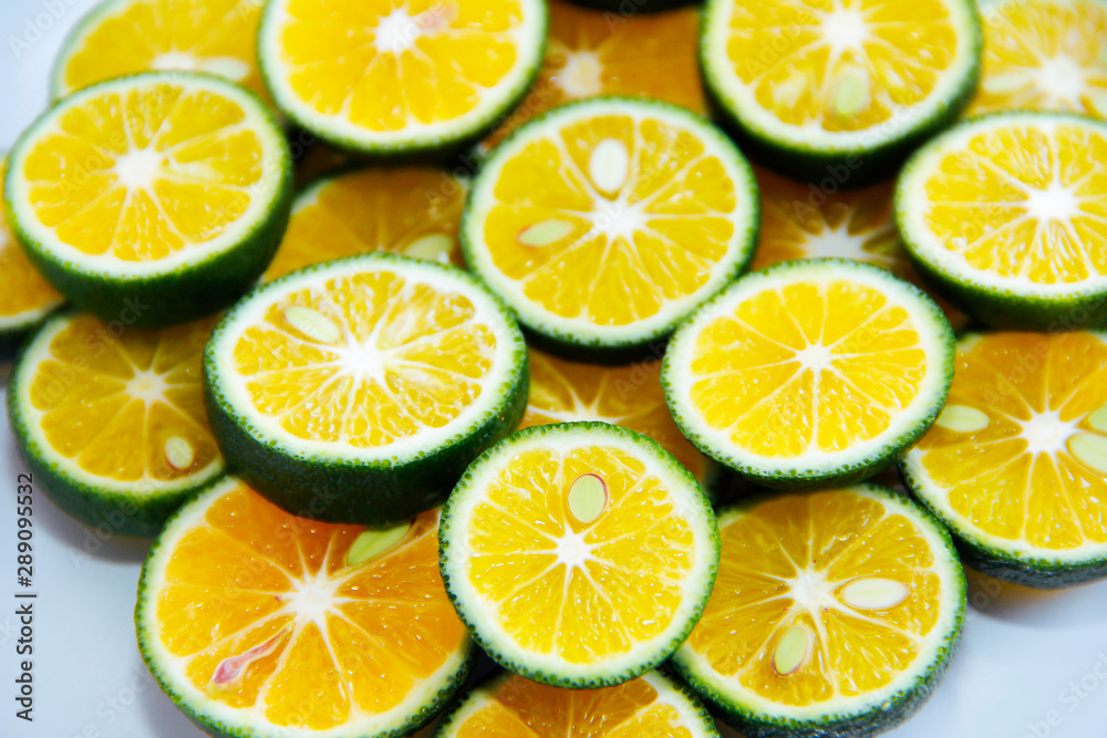 round slices of natural fresh tangerines, oranges, lemon, lime with green peel round slices of natural fresh tangerines, oranges, lemon, lime with green peel