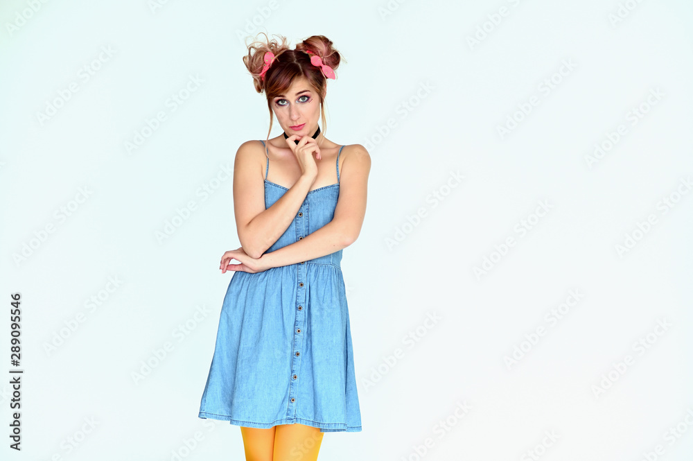 Portrait of a cute happy funny blonde girl with colored hair in a funny dress on a white background. Smiling in various poses, beauty, holiday.