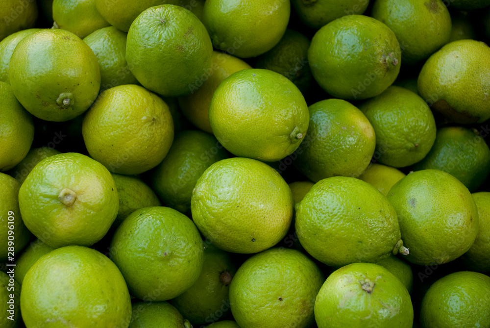 Lime Citrus Fruits, green and yellow, at the local farmer market, Milan, Italy Lime Citrus Fruits, green and yellow, at the local farmer market, Milan, Italy