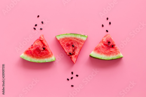 Popsicle from fresh watermelon on pink background top view