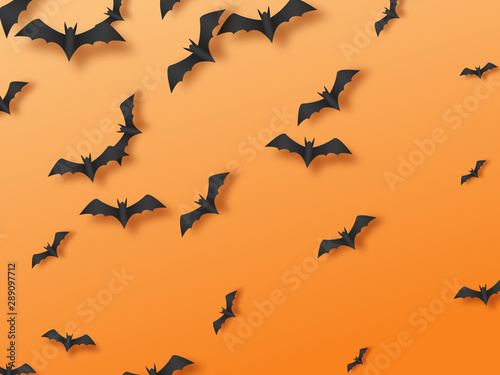 Halloween orange background with flying paper cut bats. Top view, place for text. Vector illustration.