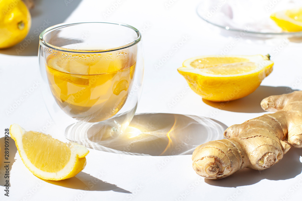 Glass of green tea with lemon and ginger close up Glass of green tea with lemon and ginger close up