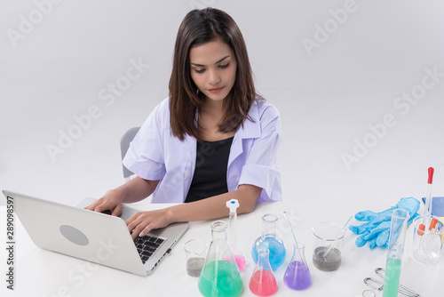 Cheerful  asian chemist woman in lap, or graduate student in lab coat ane protetive wear work,check and test chemistry. photo