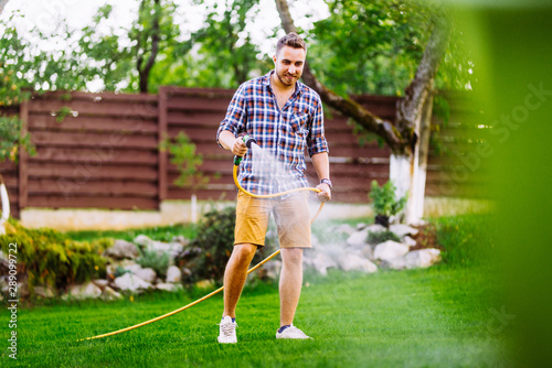 Vászonkép Caucasian man working on grass irrigation
