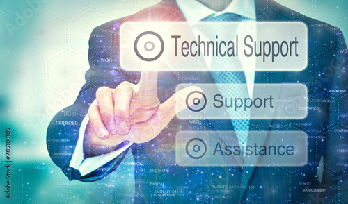 A businessman selecting a Technical Support button on a futuristic display with a concept written on it.