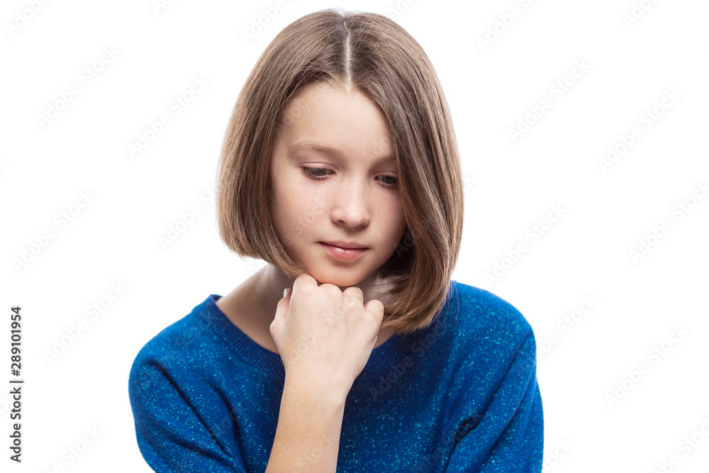 A cute teenager girl in a blue sweater thought, propping her head on her hand. Isolated over white background. A cute teenager girl in a blue sweater thought, propping her head on her hand. Isolated over white background.