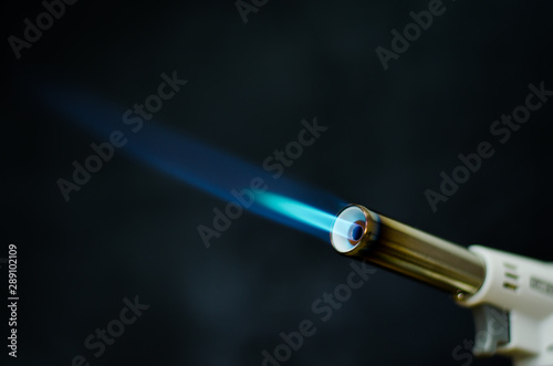 gas flame gun torch blue fire butane white background