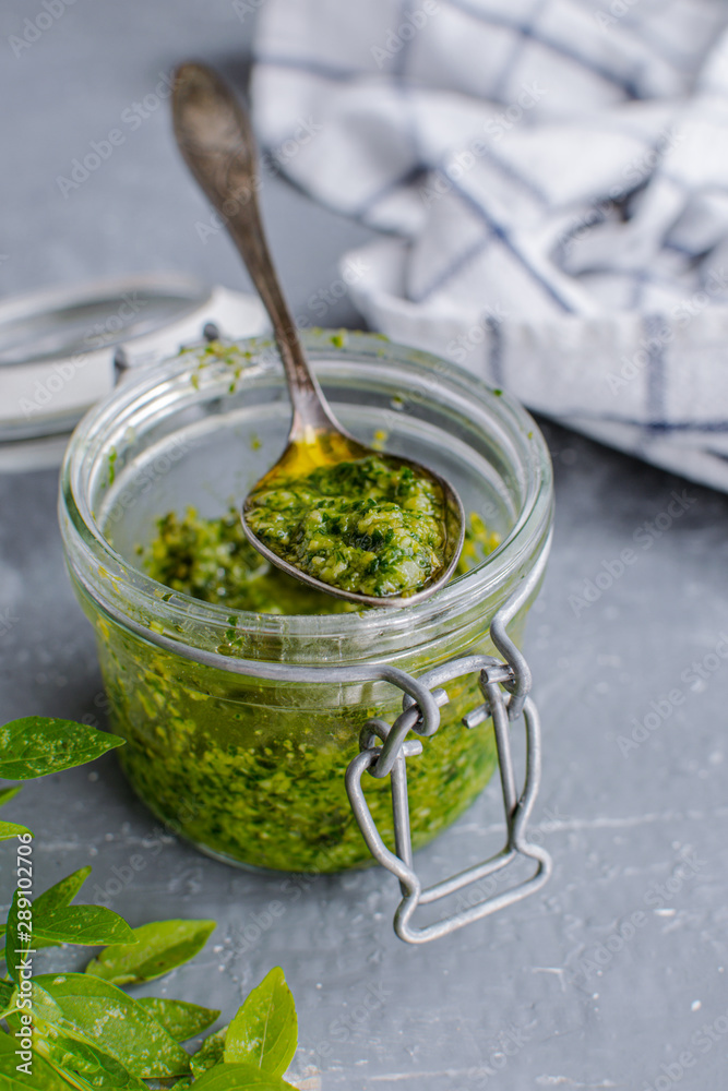 Glass jar with pesto sauce, top view Glass jar with pesto sauce, top view
