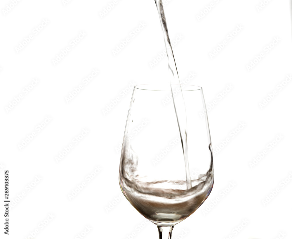 Water splashing in wine glass isolated on white