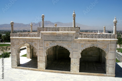 A small mosque in the Gardens of Babur, Kabul, Afghanistan. A white marble mosque and Kabul city view with trees and mountains. Mosque, Gardens of Babur, Kabul, Afghanistan 2005.