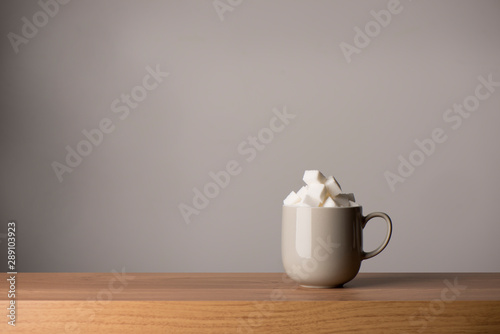 Ceramic Coffee Mug Filled with Sugar Cubes  Copy Space