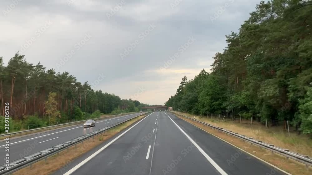 autobahn road in Germany. Asphalt road, colorful trees, sunny sky. Car travel, second floor bus point of view autobahn road in Germany. Asphalt road, colorful trees, sunny sky. Car travel, second floor bus point of view