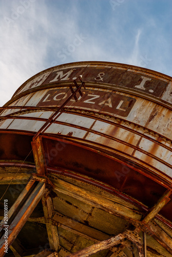 Louzal or Lousal pyrite Mine in Portugal, view of the rusty vintage water tank in the abandoned railway station. photo