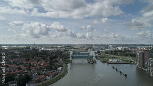 the lifted Algera flood barrier in the river Hollandse IJssel in the background on a sunny day in summertime photo