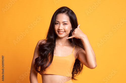 Young Asian woman show with phone gesture.