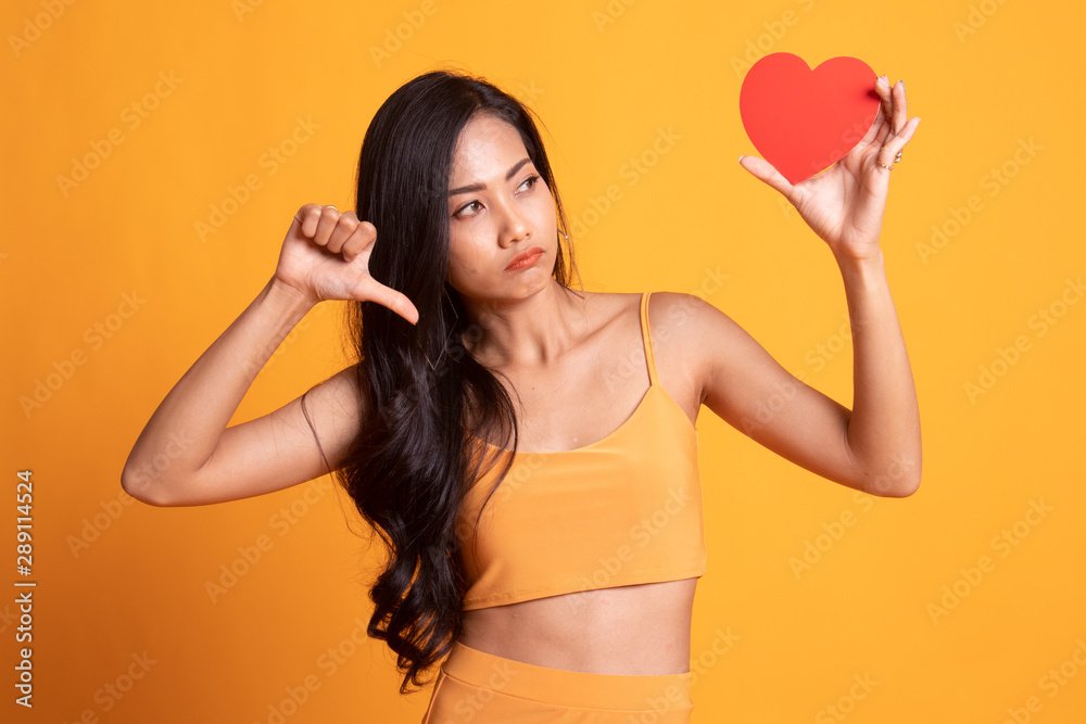Asian woman thumbs down with red heart. Asian woman thumbs down with red heart.