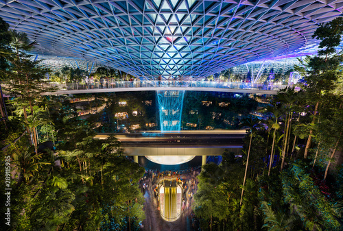 The Jewel at Changi Airport, with the rain vortex indoor waterfall illuminated during the light show, Singapore
