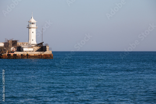 Sea lighthouse against the blue sea.